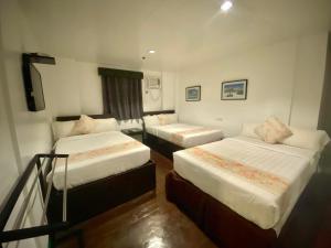 a hotel room with two beds and a balcony at Emerald Bay Boracay in Boracay