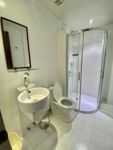 a bathroom with a toilet and a sink and a shower at Emerald Bay Boracay in Boracay