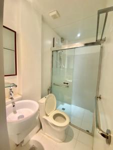 a bathroom with a shower and a toilet and a sink at Emerald Bay Boracay in Boracay