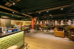 un restaurante con mesas y sillas amarillas y verdes en Roaders Hotel - Zhonghua, en Taipéi