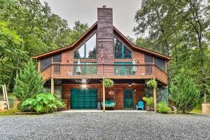 a house with a wrap around porch with a deck at Ellijay Resort Cabin with Deck and Enclosed Porch! in Ellijay