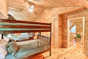 a bedroom with two bunk beds in a log cabin at Ellijay Resort Cabin with Deck and Enclosed Porch! in Ellijay