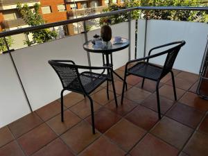 - Balcón con mesa pequeña y 2 sillas en Hermoso apartamento con piscina a 300m de la playa, en Lloret de Mar