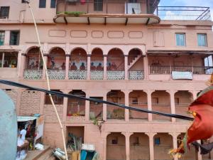 a building with people sitting on the balconies of it at Sunrise Lodge in Varanasi