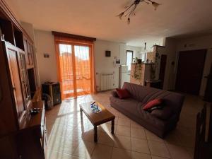 a living room with a couch and a coffee table at Casa Gianfranco in Gubbio