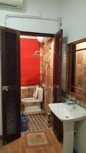 a bathroom with a white sink and a toilet at Best Price Hồ Gươm Apartments for Long Stay in Hanoi