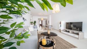 uma sala de estar com um sofá e uma mesa em Hashtag Holiday Home - Luxury 2BDR Apartment on The Palm Azure Residences em Dubai