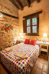 a bedroom with a large bed with two tables at Sierra de Gata EL CORRAL DE LA HIGUERA in Torre de Don Miguel