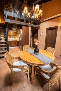 a dining room with a wooden table and chairs at Sierra de Gata EL CORRAL DE LA HIGUERA in Torre de Don Miguel +67 photos