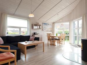 a living room with a couch and a table at 6 person holiday home in GROEMITZ in Grömitz