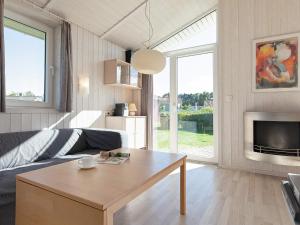 a living room with a couch and a table at Two-Bedroom Holiday home in Grömitz 10 in Grömitz