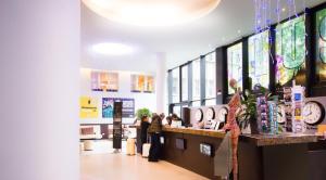 a store with people standing at a counter at PLUS Berlin Hostel und Hotel in Berlin