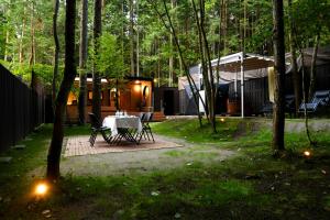 a table and chairs in a yard with a house at Fuji Fumoto Forest Hotspring ふもとの森温泉 in Fujikawaguchiko +102 photos