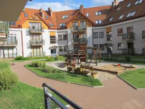 a courtyard with a playground in front of some buildings at Apartament Studio in Giżycko