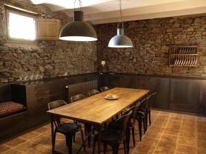 a dining room with a wooden table and chairs at Ca l'Agnès in Montseny