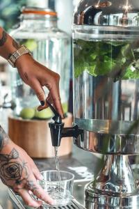 a person is making a drink in a mixer at Comfort Hotel Malmö in Malmö