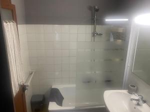 a bathroom with a shower and a sink and a tub at Casa Laureano in Carcedo +18 photos