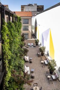 a courtyard with chairs and tables on a building at Savona 18 Suites in Milan