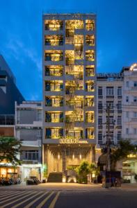 a tall building with a hotel sign on it at LEGEND Boutique Hotel in Da Nang