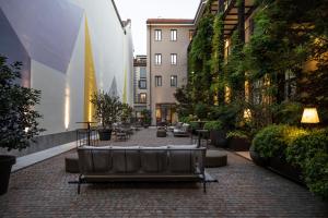 a brick walkway with a couch in a city at Savona 18 Suites in Milan