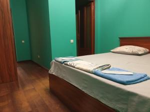 a bedroom with a bed with blue walls at Orran Hotel and Resort in Solak