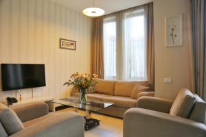 a living room with a couch and a tv at Monte Carlo in Batumi