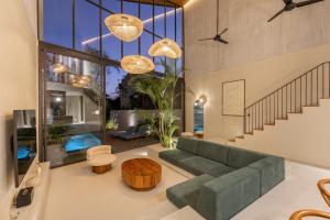 a living room with a green couch and a table at ASAI Village in Jimbaran +140 photos