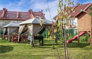 a garden with a tent and a playground at Beautiful Home In Mielno With Wifi in Mielno