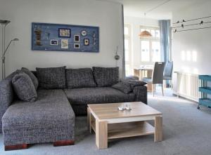 a living room with a couch and a coffee table at Ferienwohnung strandnah mit Balkon in Ostseebad Koserow