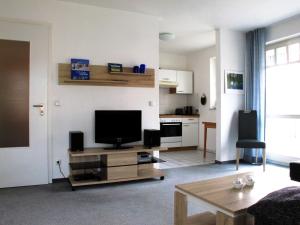 a living room with a flat screen tv on a table at Ferienwohnung strandnah mit Balkon in Ostseebad Koserow