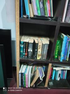a book shelf filled with lots of books at Marine Apartments in Honiara