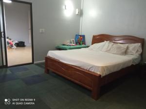a bedroom with a large bed with a mirror at Marine Apartments in Honiara