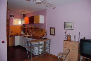 a kitchen with a table and chairs and a tv at Sol y playa in Benalmádena