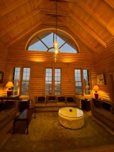 een grote woonkamer met een bank en een tafel bij Chalet de Charme, Cedar, Lebanon, ENTIRE CHALET in Al Arz