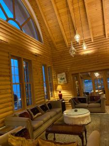 a living room with couches and a table in a building at Chalet de Charme, Cedar, Lebanon, ENTIRE CHALET in Al Arz