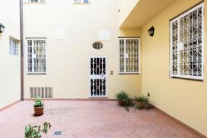 an empty room with doors and potted plants at De'Gombruti, Bologna by Short Holidays in Bologna
