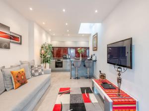 a living room with a couch and a tv at The Otter - Uk40927 in Holdenhurst