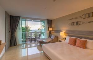 a hotel room with a bed and a balcony at Centara Ao Nang Beach Resort & Spa Krabi - SHA Plus in Ao Nang Beach