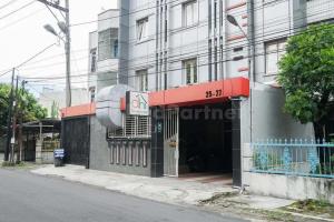 a building with a sign in front of it at Deli Homestay near DeliPark Mall Medan RedPartner in Medan