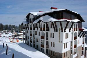 a large building with snow on top of it at Апартамен в Манастира 3 in Smolyan