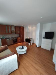 a living room with a couch and a table at Central bus station apartment, wifi, tv in Narvik
