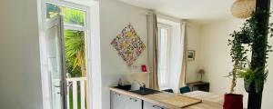 a kitchen with a sink and a window at CLINT HOUSE - Appartement "l'Île aux Moines" in Perros-Guirec