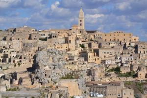 a group of buildings on top of a mountain at UltimoCasale in Matera