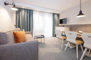 a living room with a couch and a table and chairs at Haus Verwall in Obergurgl