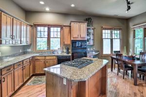a kitchen with wooden cabinets and a stove top oven at Surrounded by Natl Forest Condo with Majestic View in Burnsville