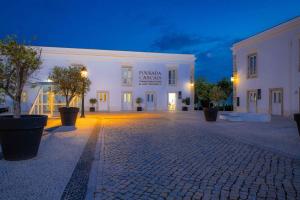 a white building with a lit up courtyard at night at Pestana Cidadela Cascais - Pousada & Art District in Cascais