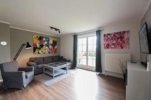 a living room with a couch and a tv at Naturferienhaus 2 in Mellnitz