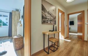 a living room with a table and a hallway at Appartement Iglsberg Top 7 in Saalbach Hinterglemm