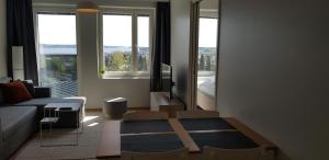 a living room with a couch and a large window at City Apartment with lake view and free parking in Kuopio