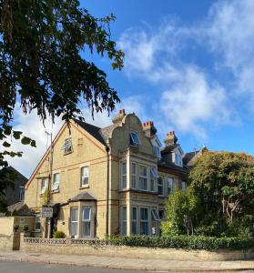 uma grande casa de tijolos ao lado de uma rua em A & B Guest House Cambridge Ltd em Cambridge